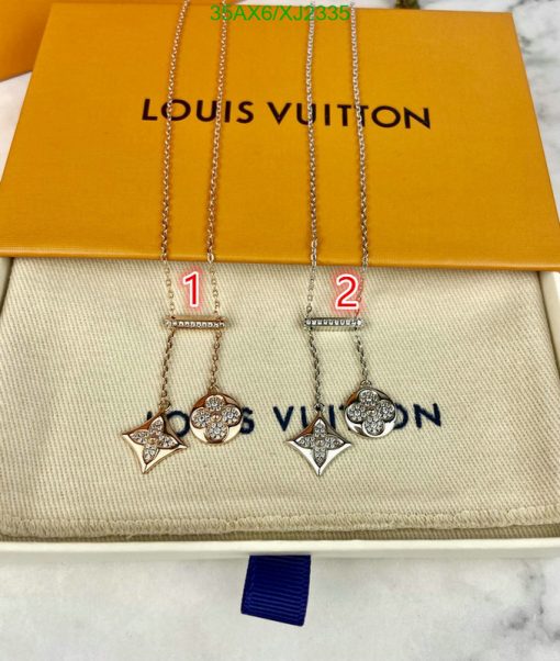 Louis Vuitton branded pendant necklaces displayed in box.