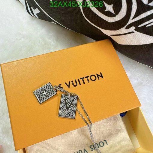 Luxury brand box with stylish pendant and patterned scarf.