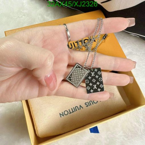 Hand holding designer pendant necklaces with box.