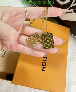 Gold pendant necklaces over branded box.